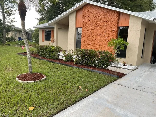 View of side of home featuring a lawn