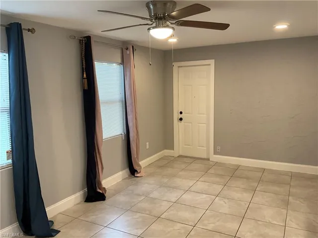Spare room with light tile flooring and ceiling fan