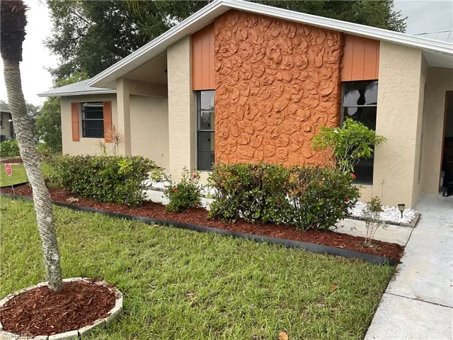 View of property exterior featuring a yard