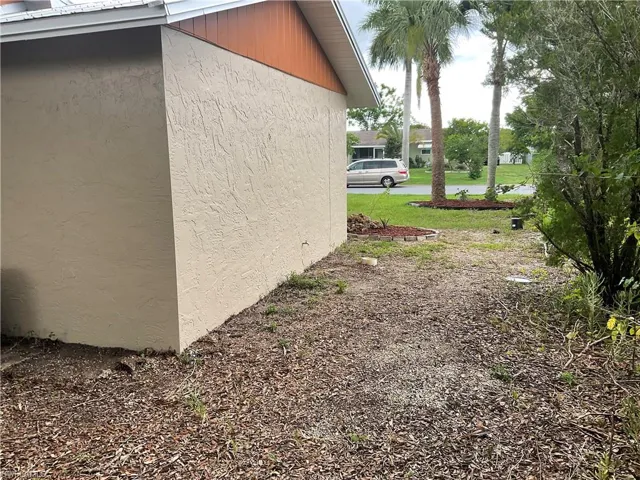 View of property exterior with a lawn