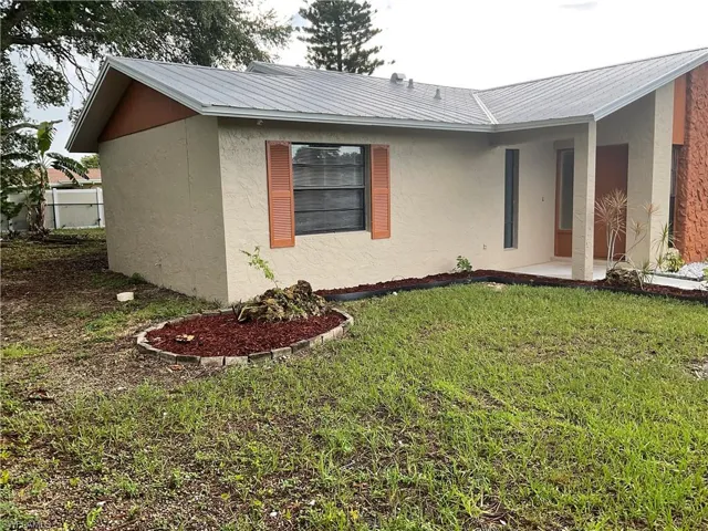 View of front of property featuring a front lawn