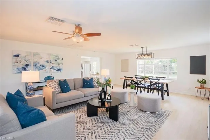 Living room with a ceiling fan and wood finished floors