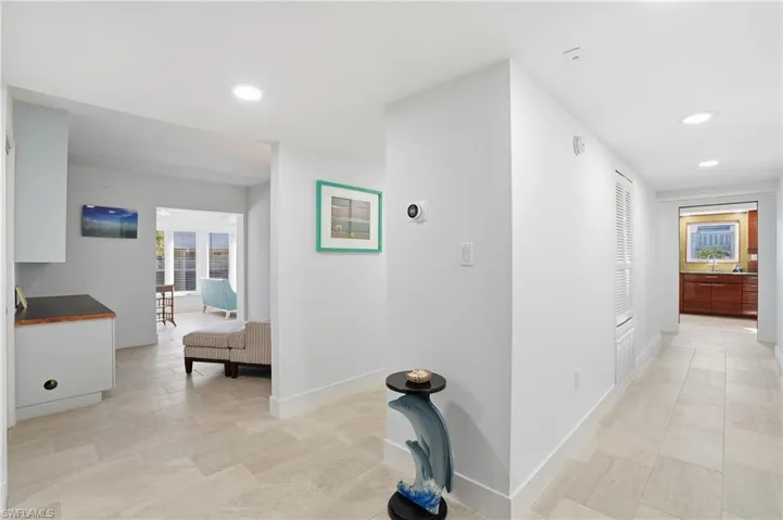 Hall with healthy amount of natural light and recessed lighting - Virtually Edited Image