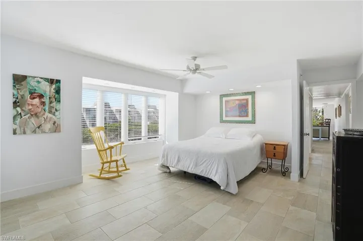 Bedroom featuring multiple windows, a ceiling fan, and recessed lighting - Virtually Edited Image