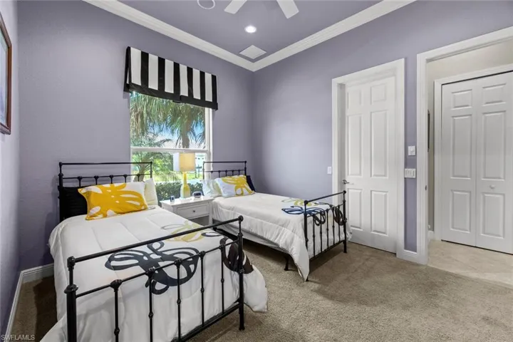 Bedroom featuring ornamental molding, carpet floors, ceiling fan, and a closet