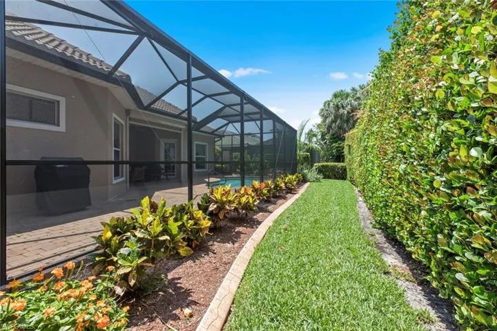 View of yard featuring a patio and a lanai