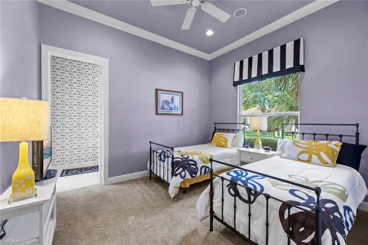 Bedroom featuring ceiling fan, crown molding, and carpet flooring