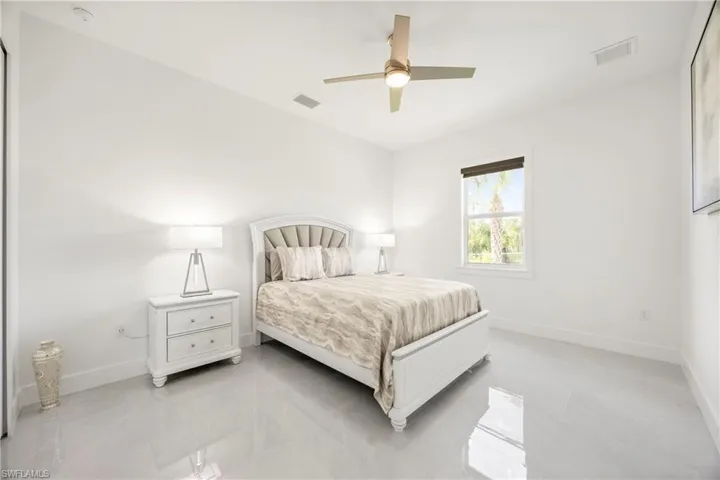Bedroom featuring a ceiling fan and baseboards