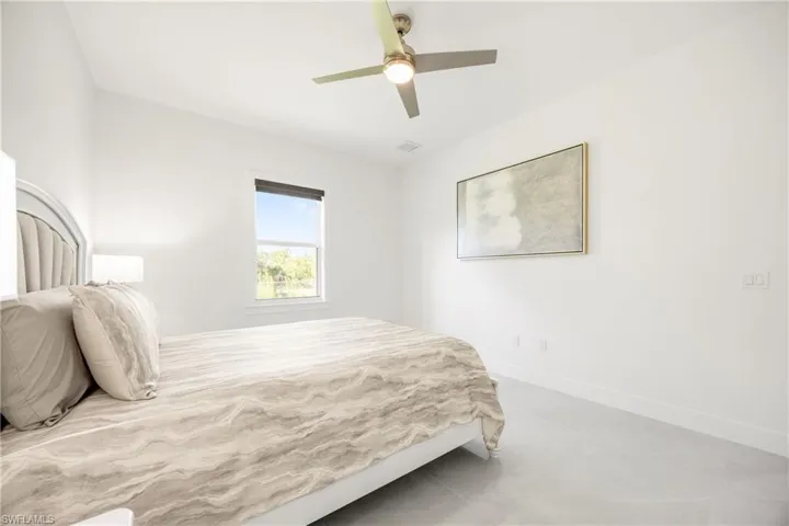Bedroom featuring a ceiling fan and baseboards