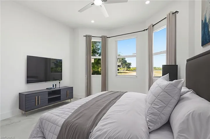 Bedroom with a ceiling fan and recessed lighting