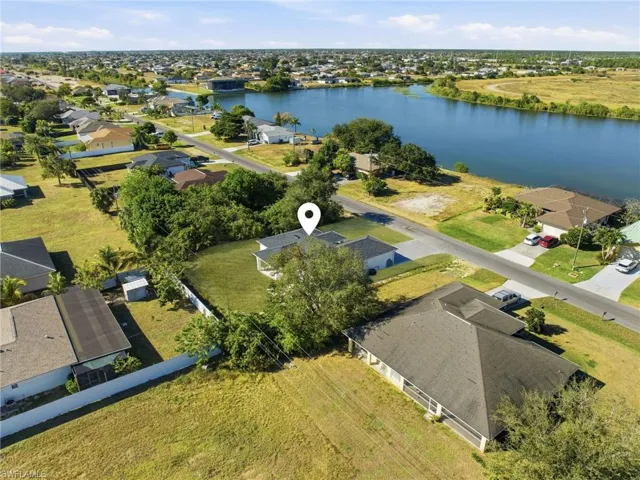 Aerial perspective of suburban area featuring a large body of water