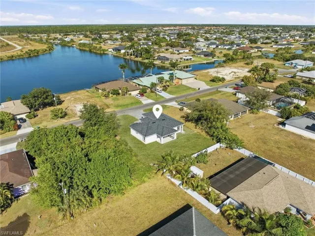 Aerial perspective of suburban area with a large body of water