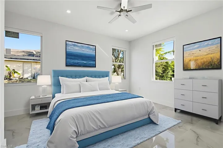 Bedroom featuring light marble finish floors, multiple windows, ceiling fan, and recessed lighting