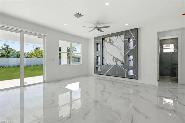 Unfurnished room featuring a ceiling fan, light marble finish flooring, and recessed lighting