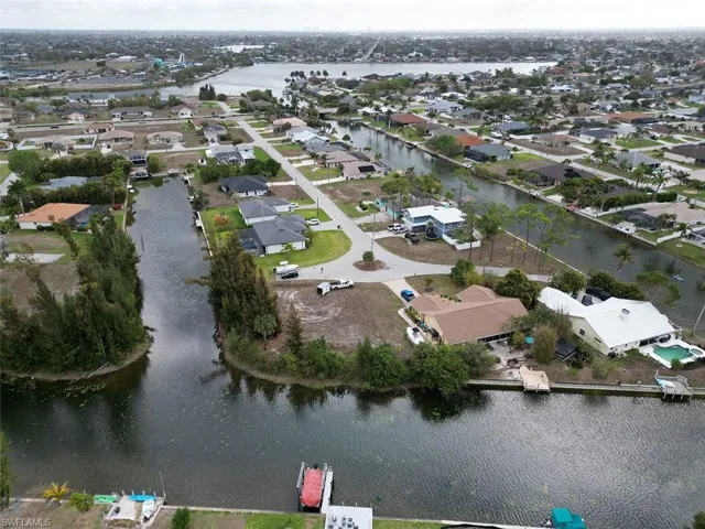 Aerial overview of property's location with nearby suburban area and a nearby body of water