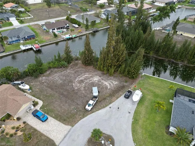 Aerial view of residential area featuring a nearby body of water