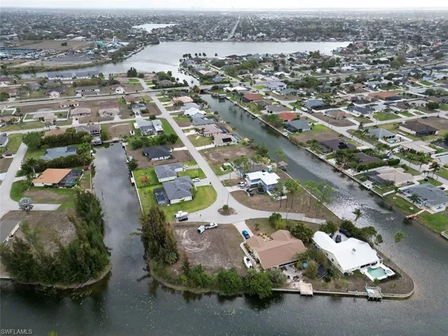 Aerial view of property's location with a large body of water and nearby suburban area