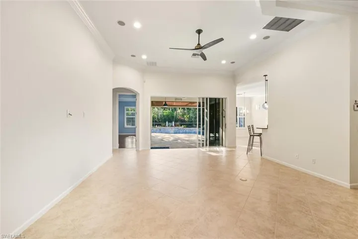 Spare room with ornamental molding, ceiling fan, recessed lighting, and arched walkways