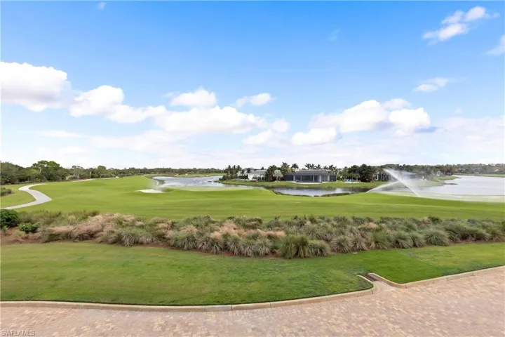 Surrounding community with a water view and a yard