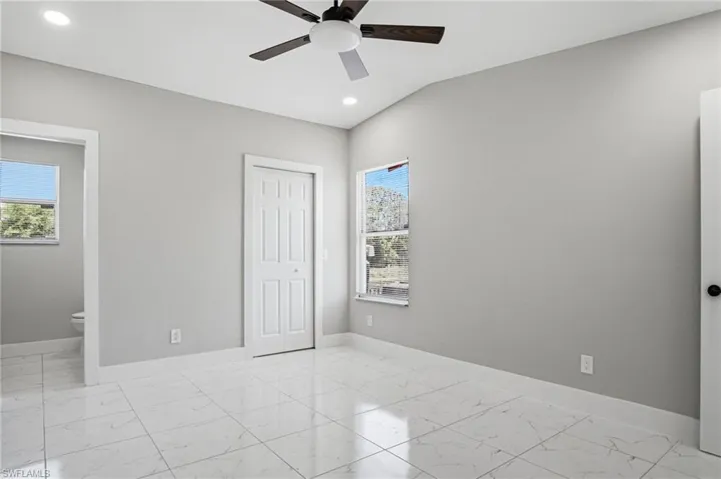 Vaulted ceiling with recessed lighting and ceiling fan