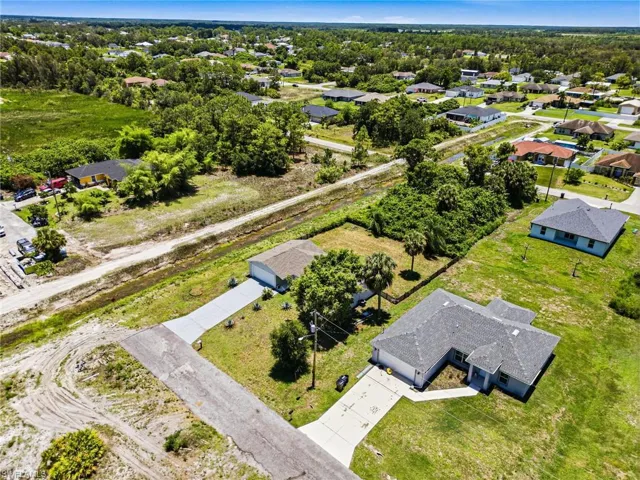 Aerial perspective highlighting multiple single-story residences with grey shingle roofs