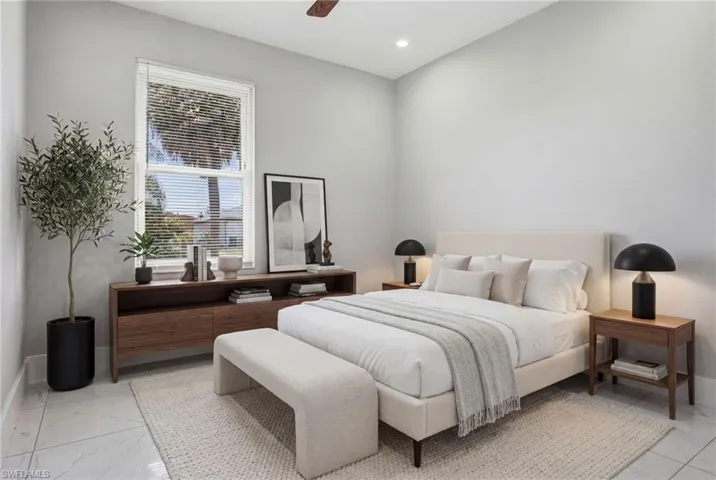 Spacious room featuring light gray walls, a window with horizontal blinds, and recessed lighting