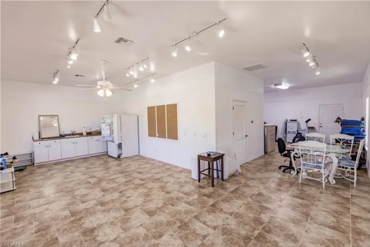 Miscellaneous room with rail lighting, ceiling fan, and sink