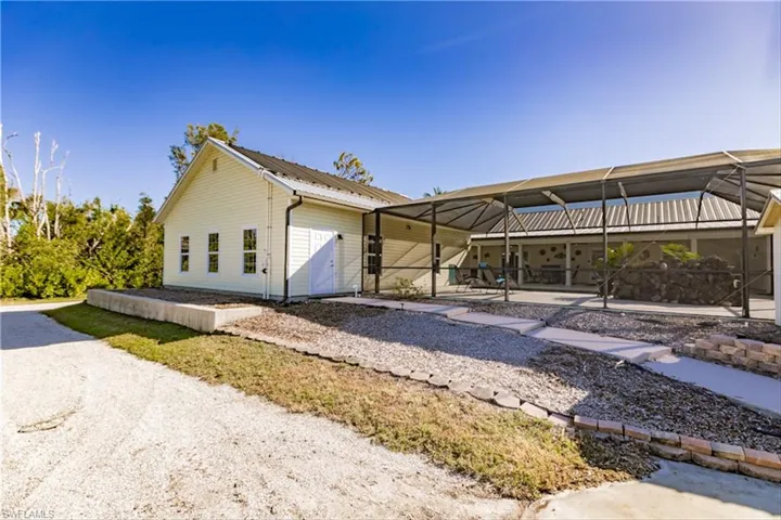 View of front of house with glass enclosure