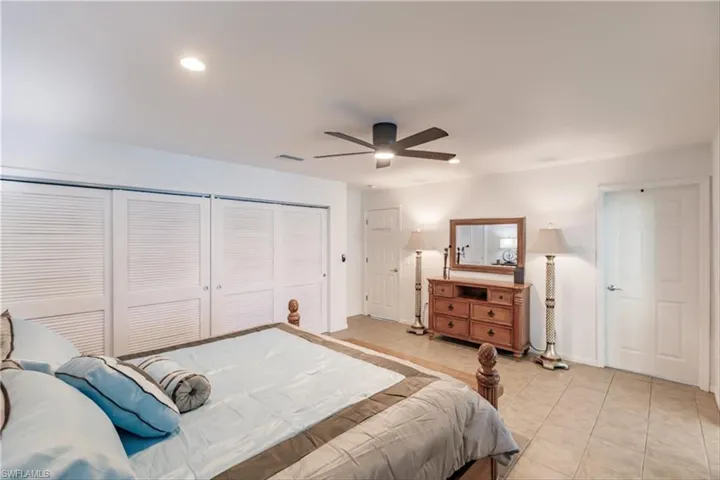 Tiled bedroom with ceiling fan