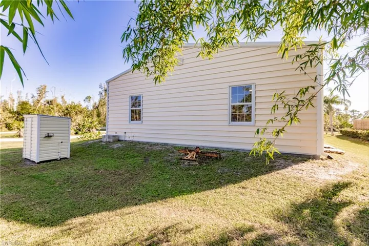 View of side of home featuring a lawn