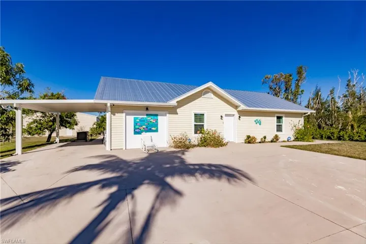 View of front facade with a carport