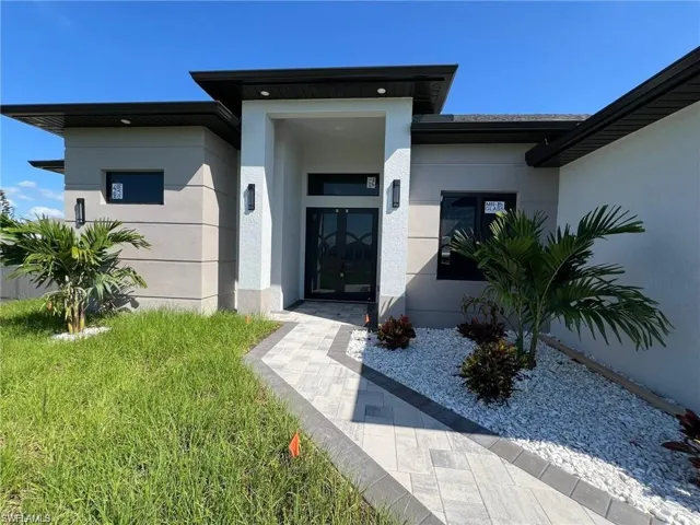 Doorway to property featuring stucco siding