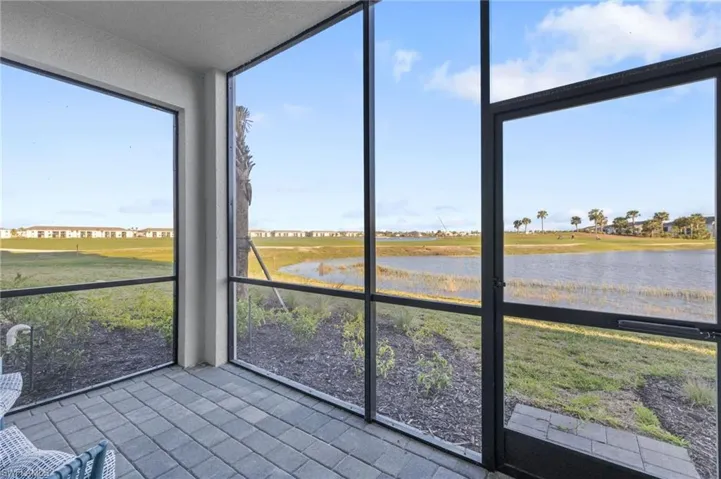 Unfurnished sunroom with a water view