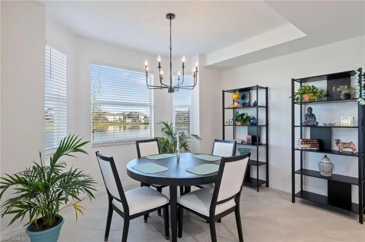 Dining room with a chandelier and light tile patterned floors