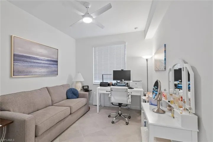 Office featuring ceiling fan and light tile patterned floors