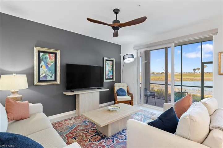 Living room with ceiling fan and a wealth of natural light