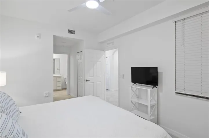 Bedroom with ceiling fan and ensuite bathroom