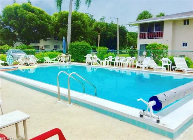 Community pool with a patio