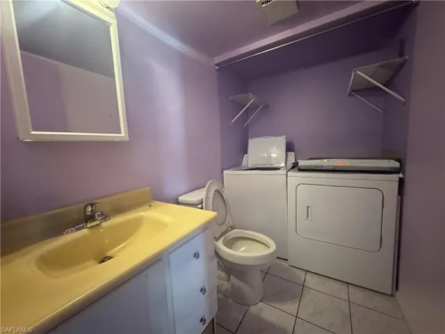 Full bathroom with vanity and separate washer and dryer