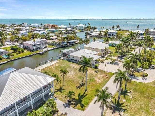 Aerial perspective of suburban area featuring a nearby body of water