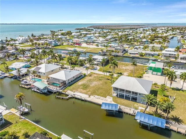 Aerial view of residential area featuring a large body of water