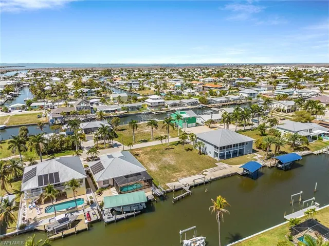 Aerial perspective of suburban area featuring a large body of water