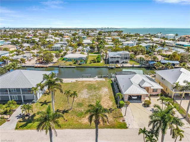 Aerial perspective of suburban area with a nearby body of water