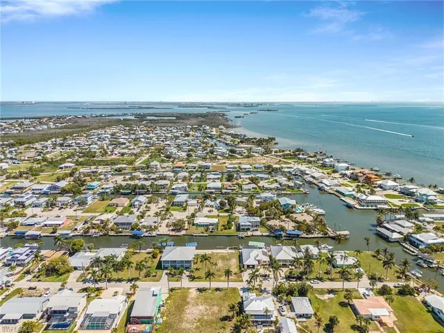 Aerial perspective of suburban area featuring a large body of water