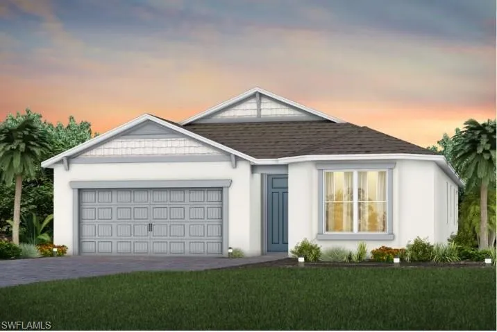 Ranch-style house featuring a garage and a yard