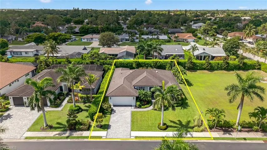 Aerial perspective of suburban area featuring property boundaries highlighted