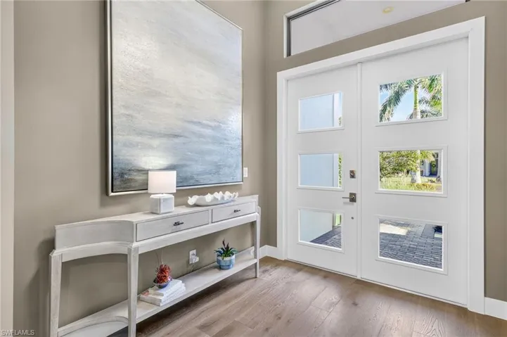 Foyer featuring Mohawk engineered wood finished floors and upgraded double door front entry