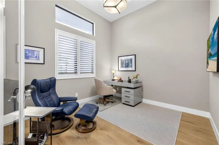 Den or 4th bedroom featuring engineered wood floors, closet, plantation shutters, and designer lighting