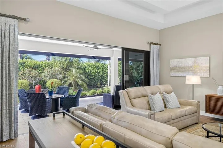 Main living area with wood finished floors, plenty of natural light, and ceiling fan