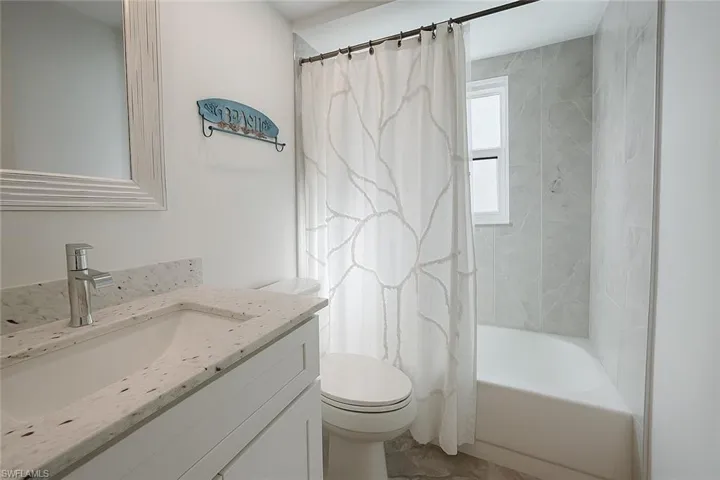 Full bathroom featuring vanity and shower / bath combo with shower curtain